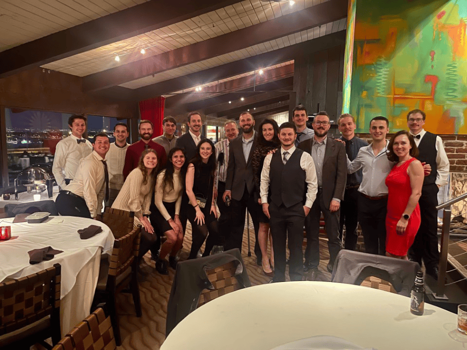 DMC's Denver team poses for a group photo in a restaurant.