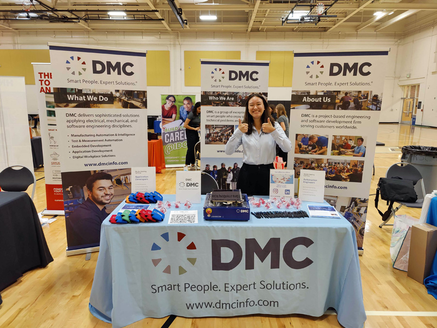 DMC employee at a career fair booth